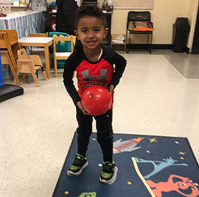 boy on mat using a ball