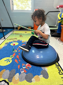 sensory path rug being used for pretend fishing